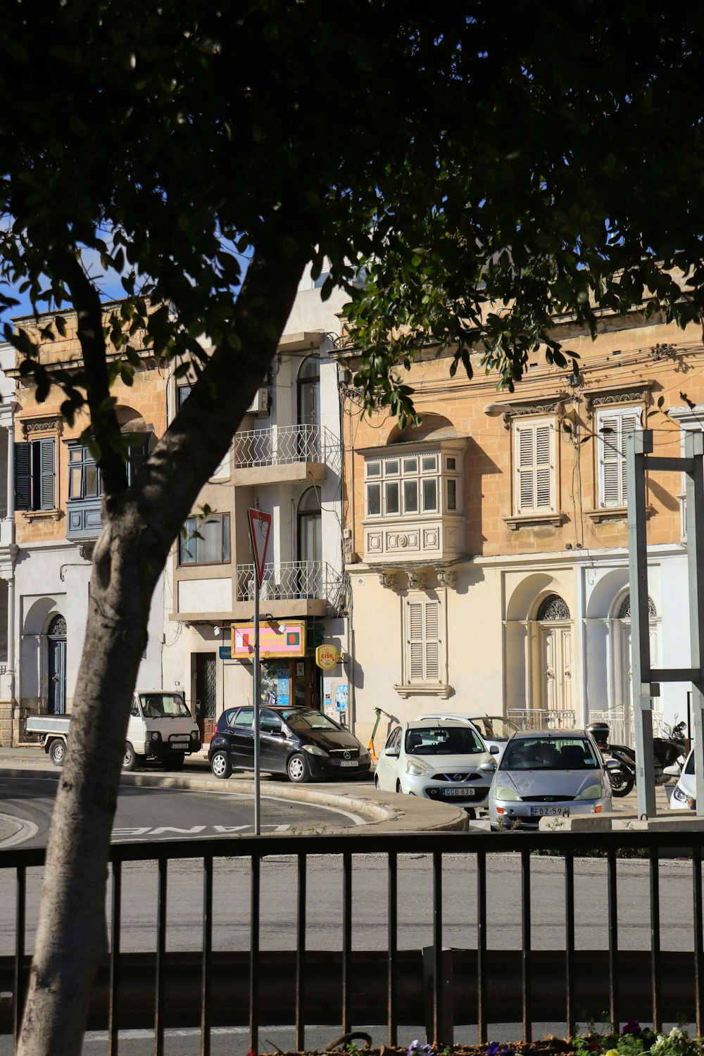 a city street with cars parked on the side of the road