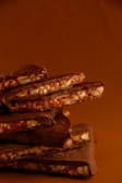 Close-up of rich, glossy dark chocolate bars stacked neatly.