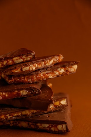 Close-up of rich, glossy dark chocolate bars stacked neatly.