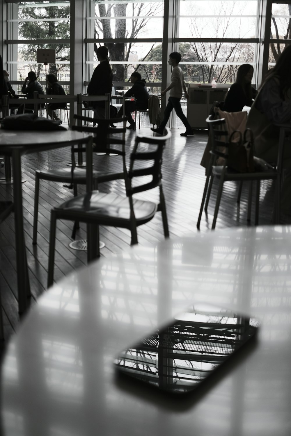 a group of people sitting at tables in a restaurant