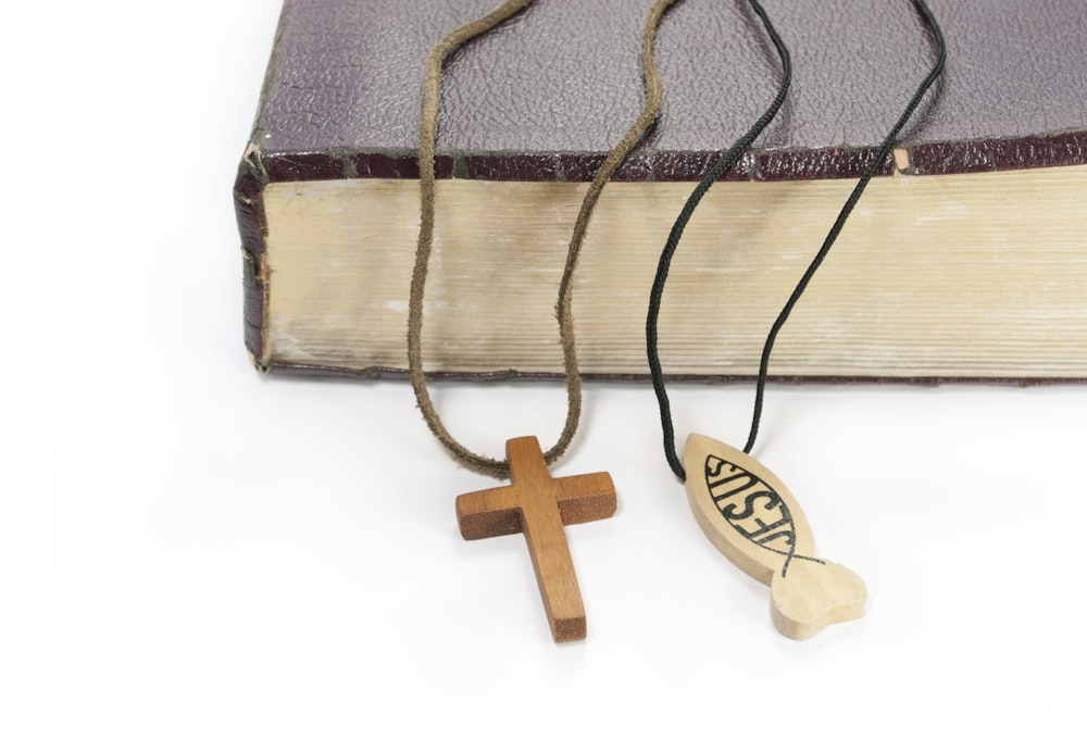 a cross and a book on a white background