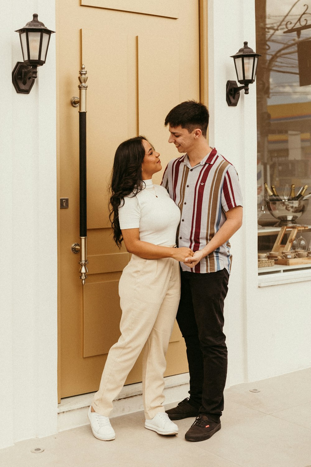 a man and a woman standing in front of a door