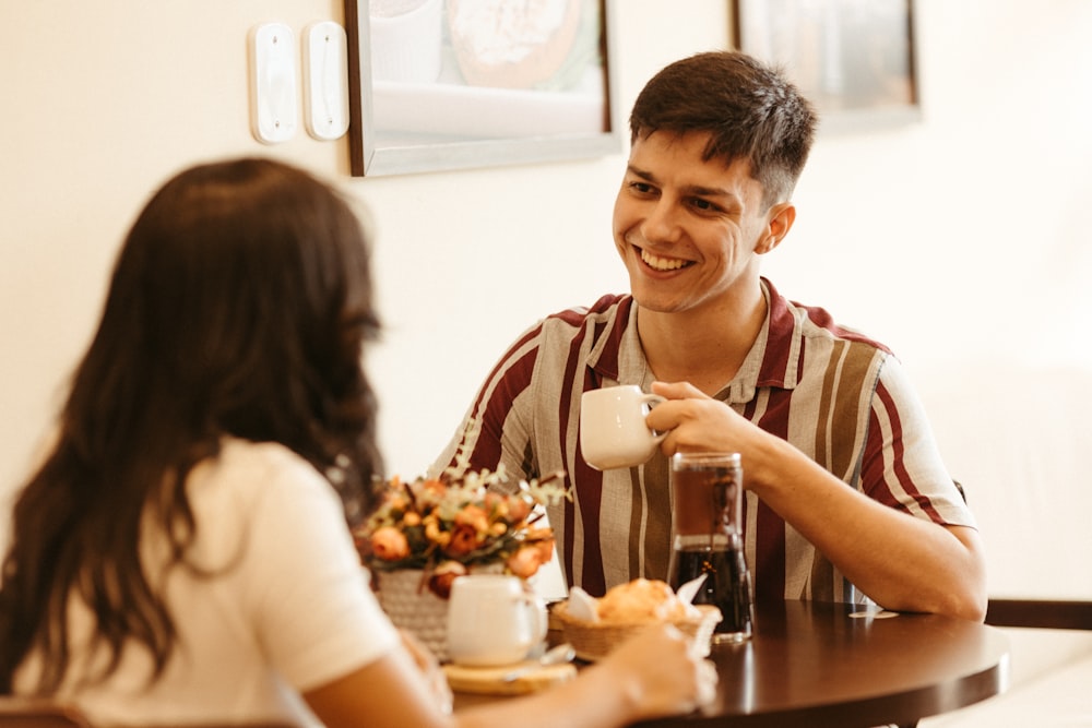 a man sitting at a table with a woman