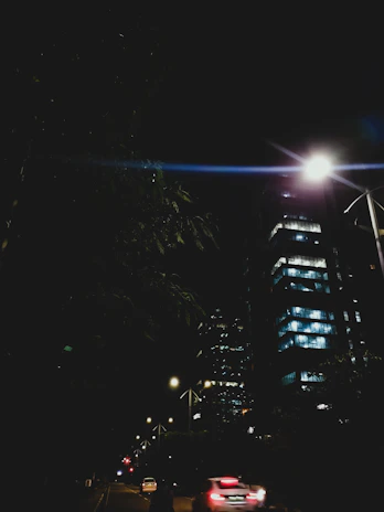 A nighttime cityscape showing vibrant streetlights and a calm urban environment.