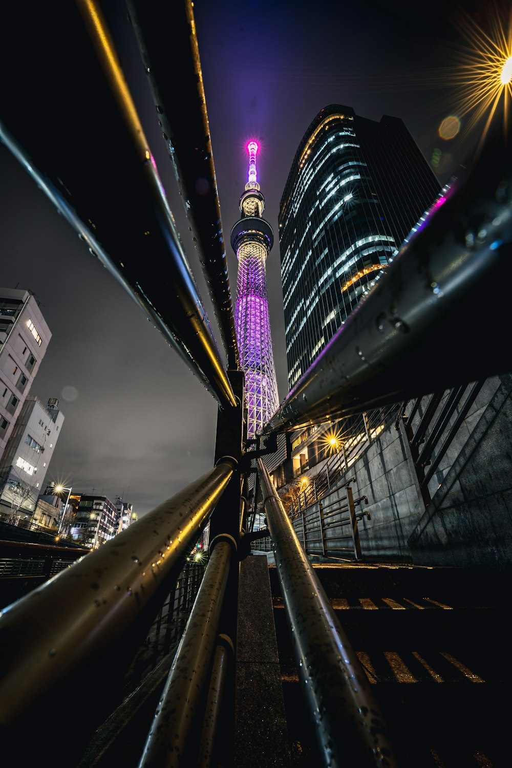 a view of a city at night from a bridge