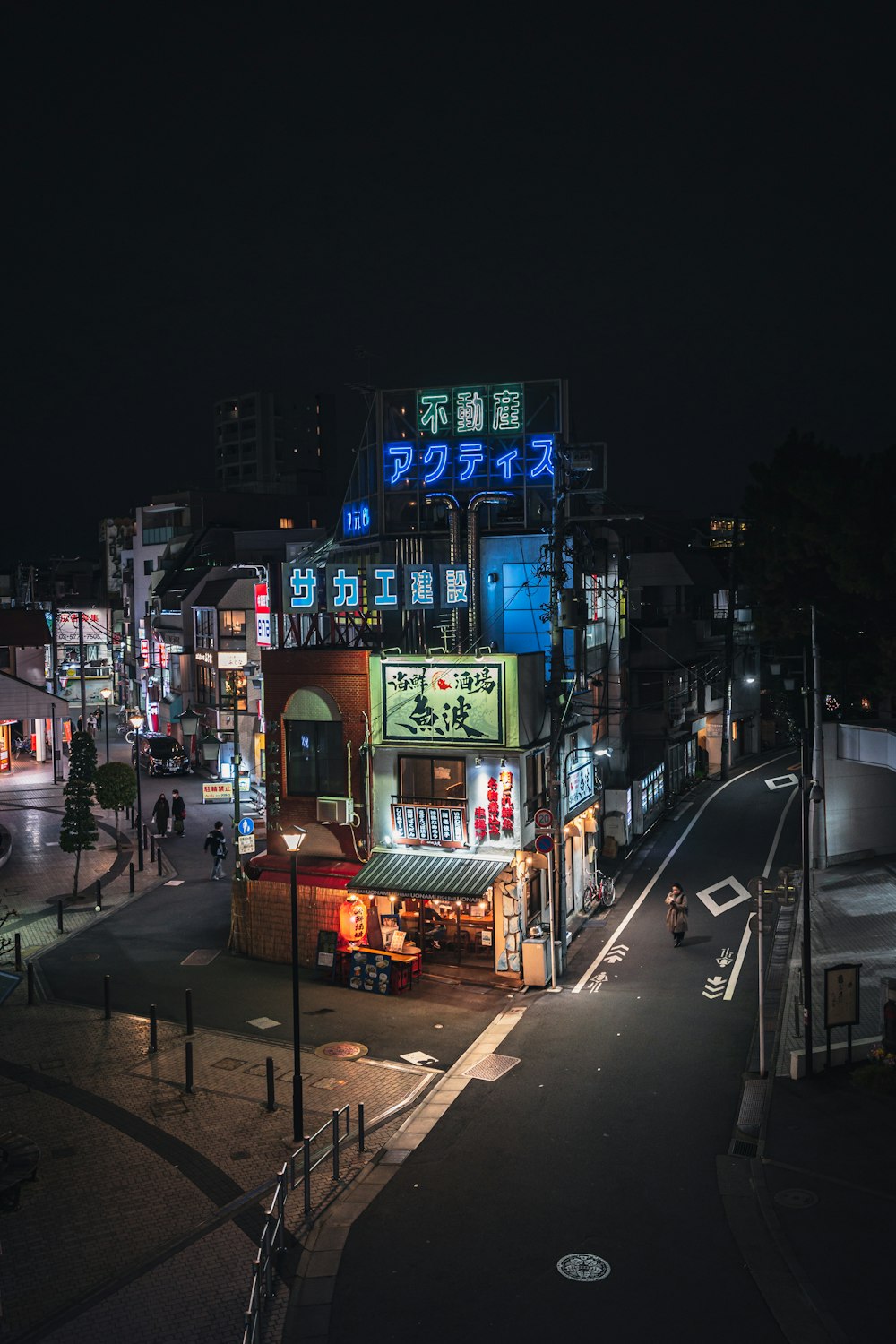 a city street at night with buildings lit up