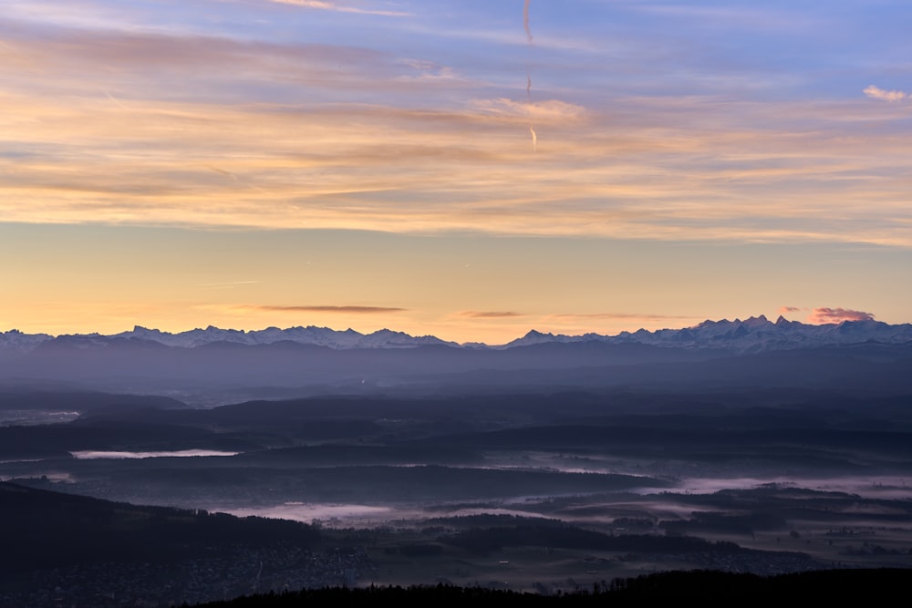 a view of a mountain range at sunset