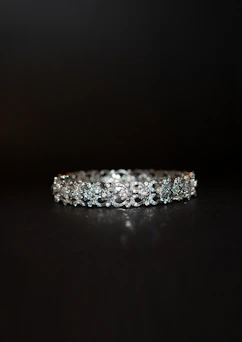 a close up of a diamond ring on a black surface