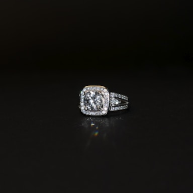 a diamond ring on a black surface