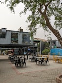 A vibrant outdoor area with seating near the container hotel.
