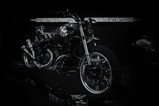 Sleek electric motorcycle prototype showcased in a modern industrial setting