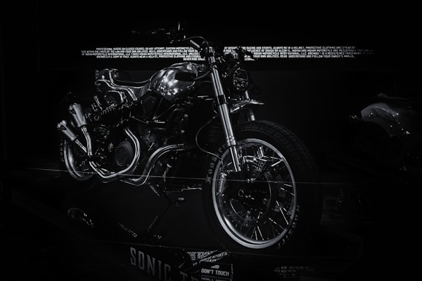 Sleek electric motorcycle prototype showcased in a modern industrial setting