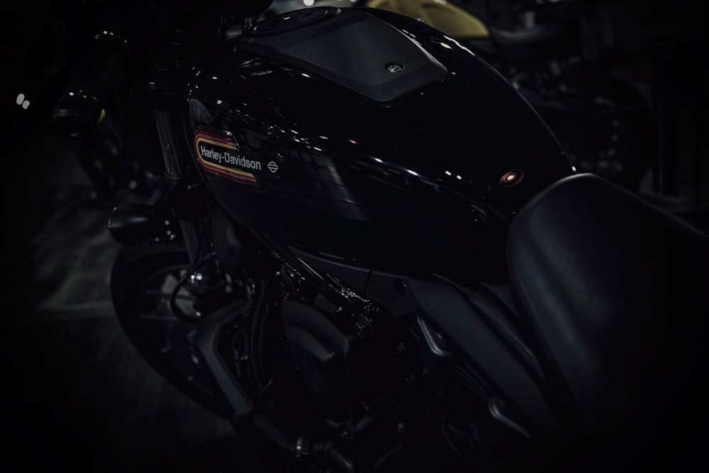 a close up of a motorcycle in a dark room