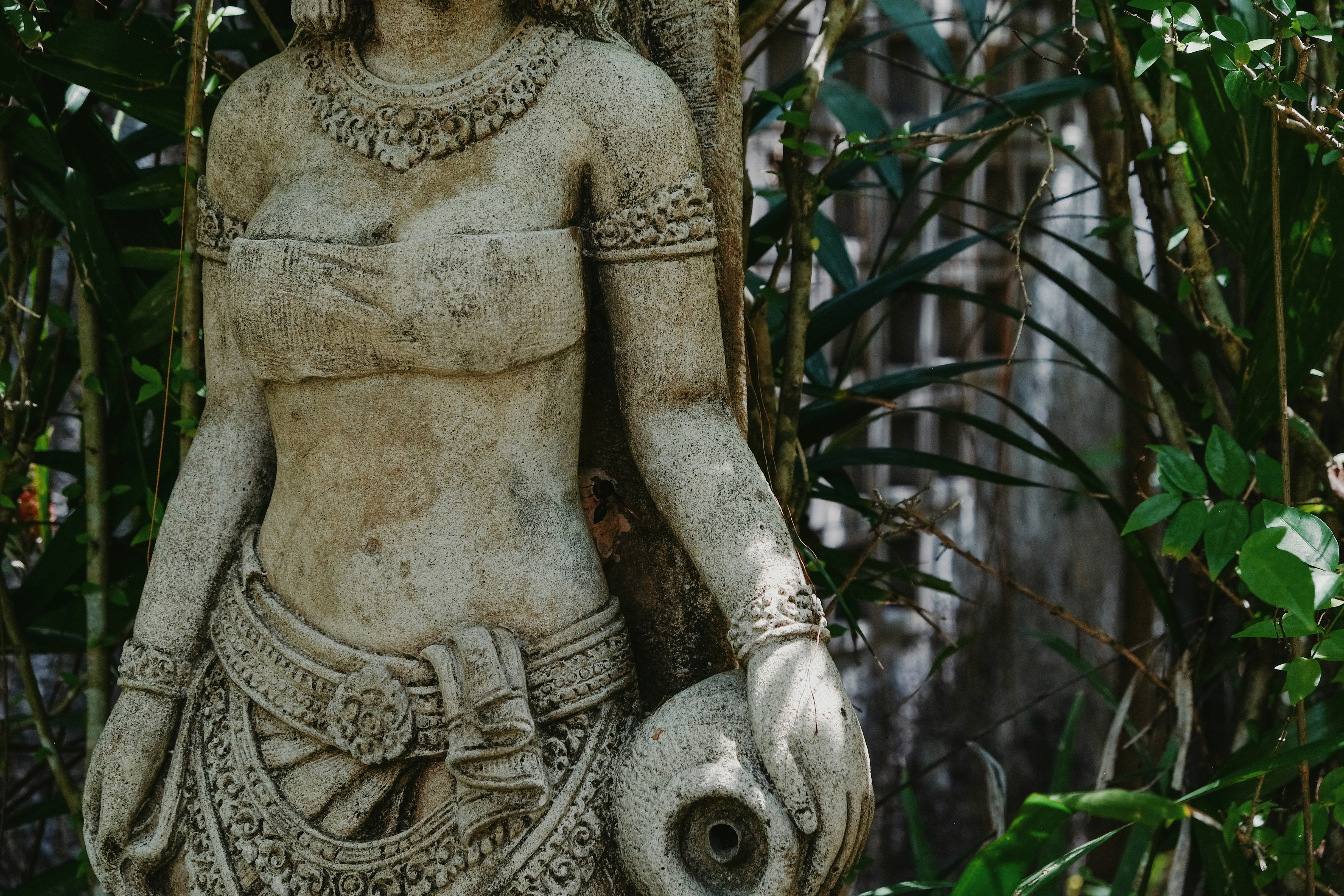 a statue of a woman holding a bird in her hand