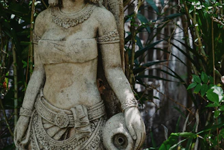 a statue of a woman holding a bird in her hand