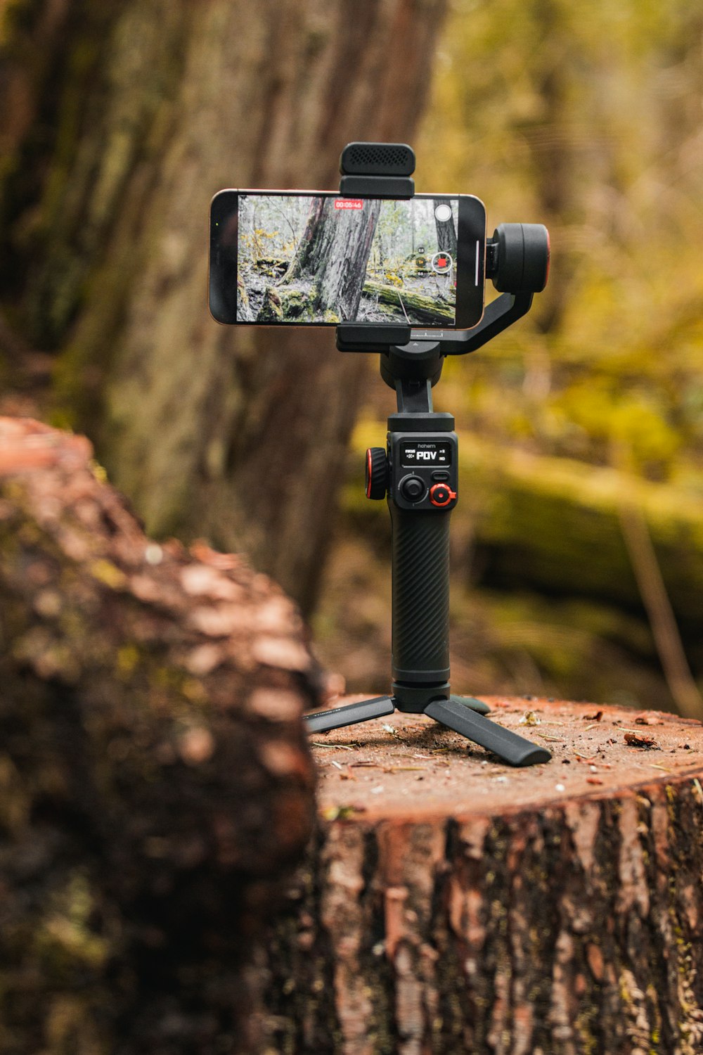 a tripod with a cell phone attached to it