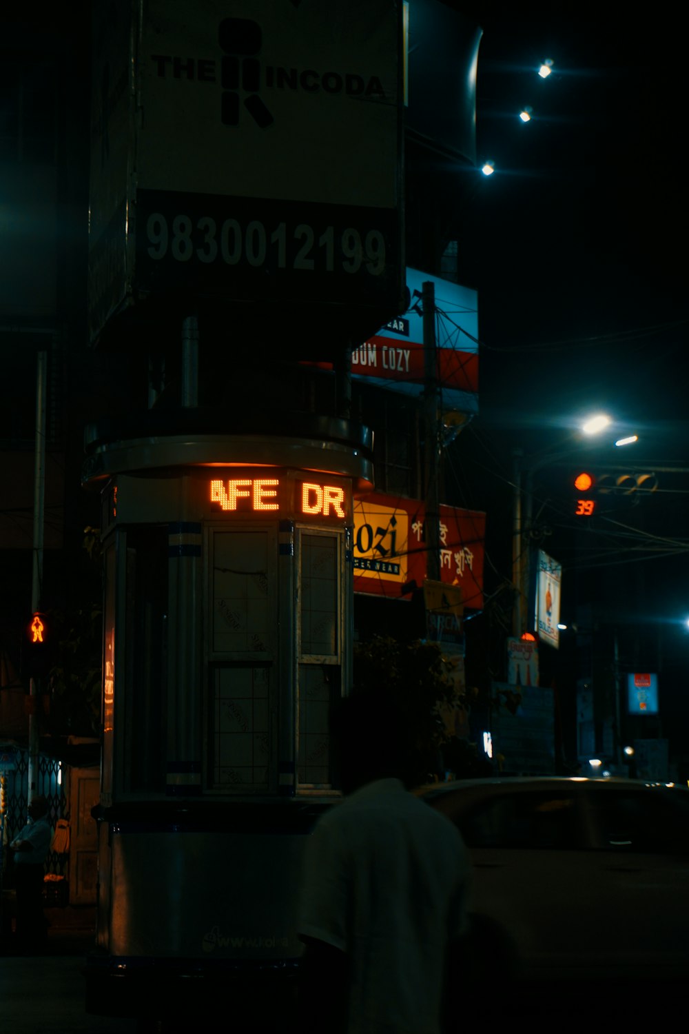 a man walking down a street at night