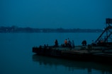 a group of people standing on a boat in the water