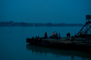 a group of people standing on a boat in the water