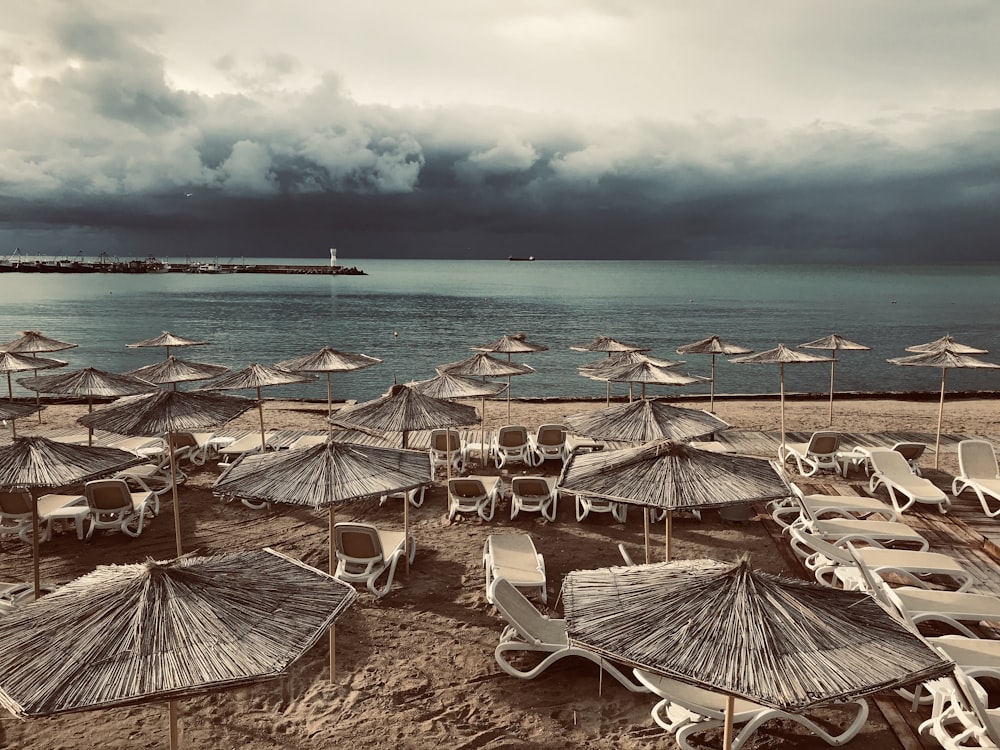 a bunch of chairs and umbrellas on a beach