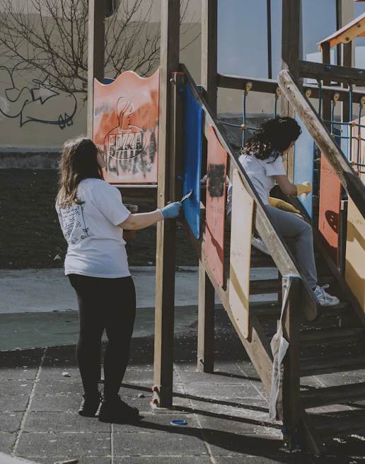 Volunteers working together to build a playground in an underserved neighborhood supported by the foundation.