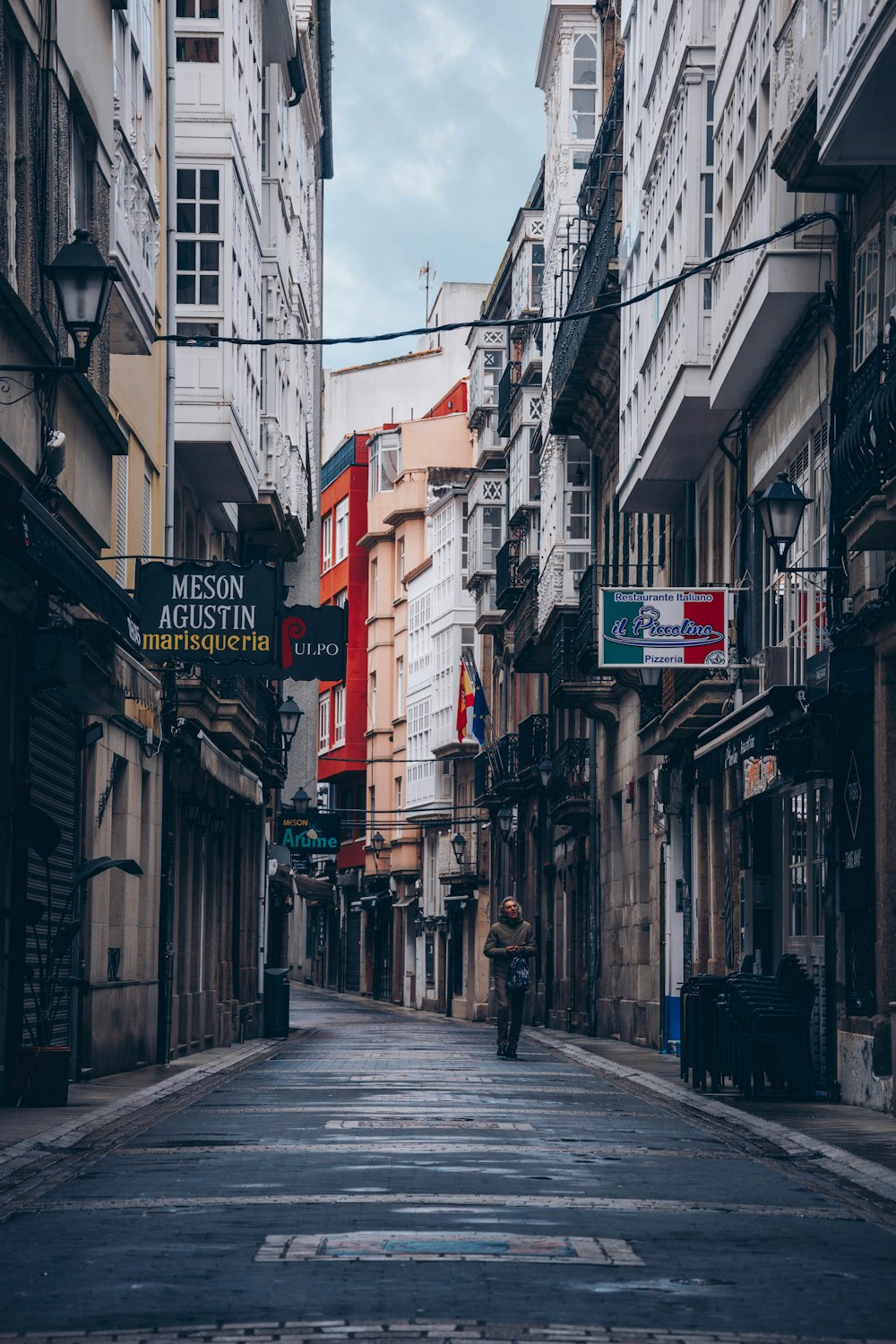 a person walking down an empty street in a city