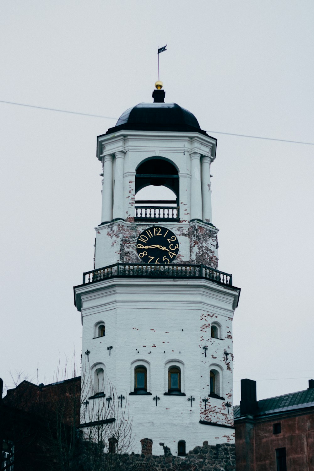 a white clock tower with a black top