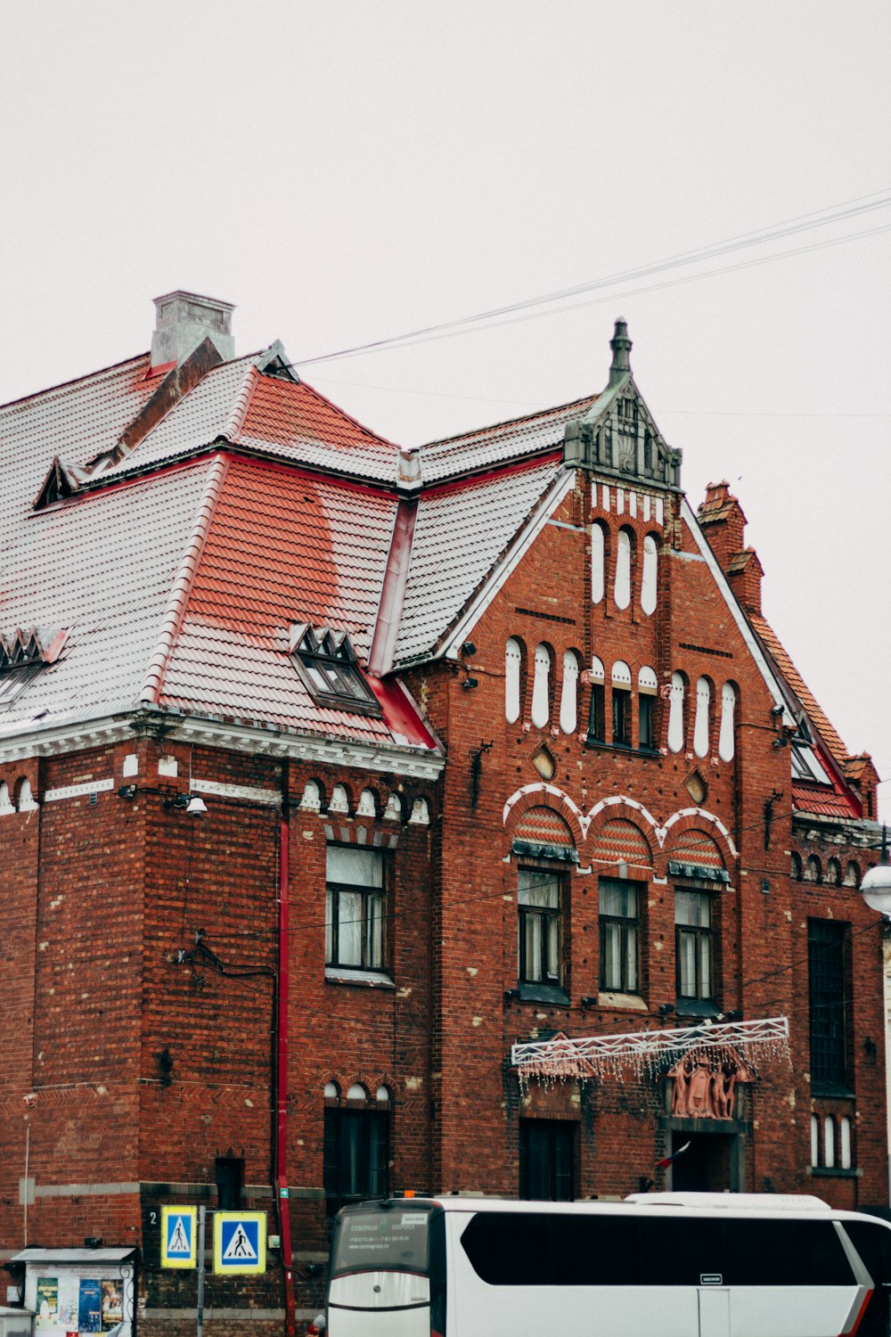 a bus is parked in front of a red brick building