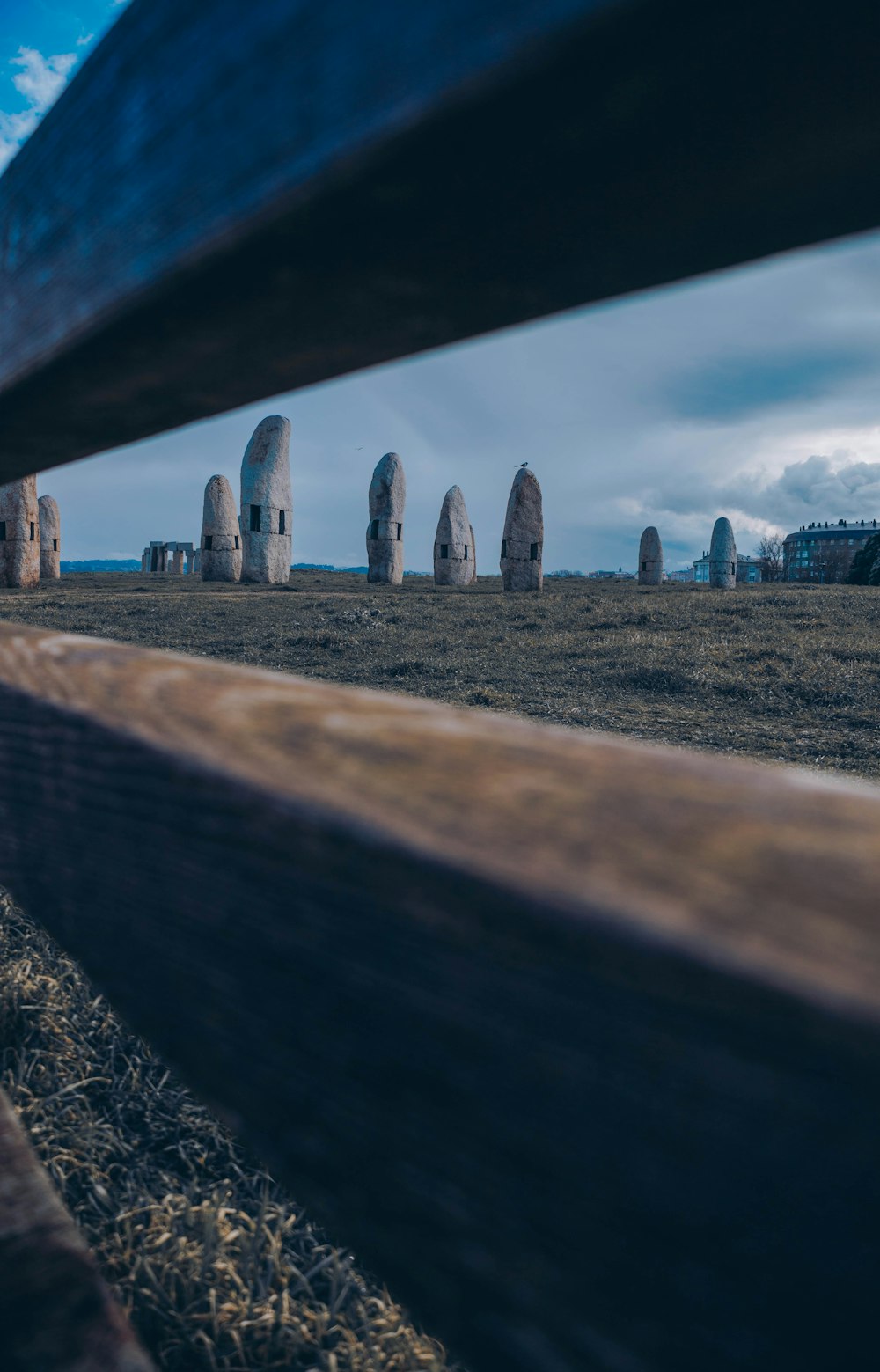 a row of stonehenge standing in a field