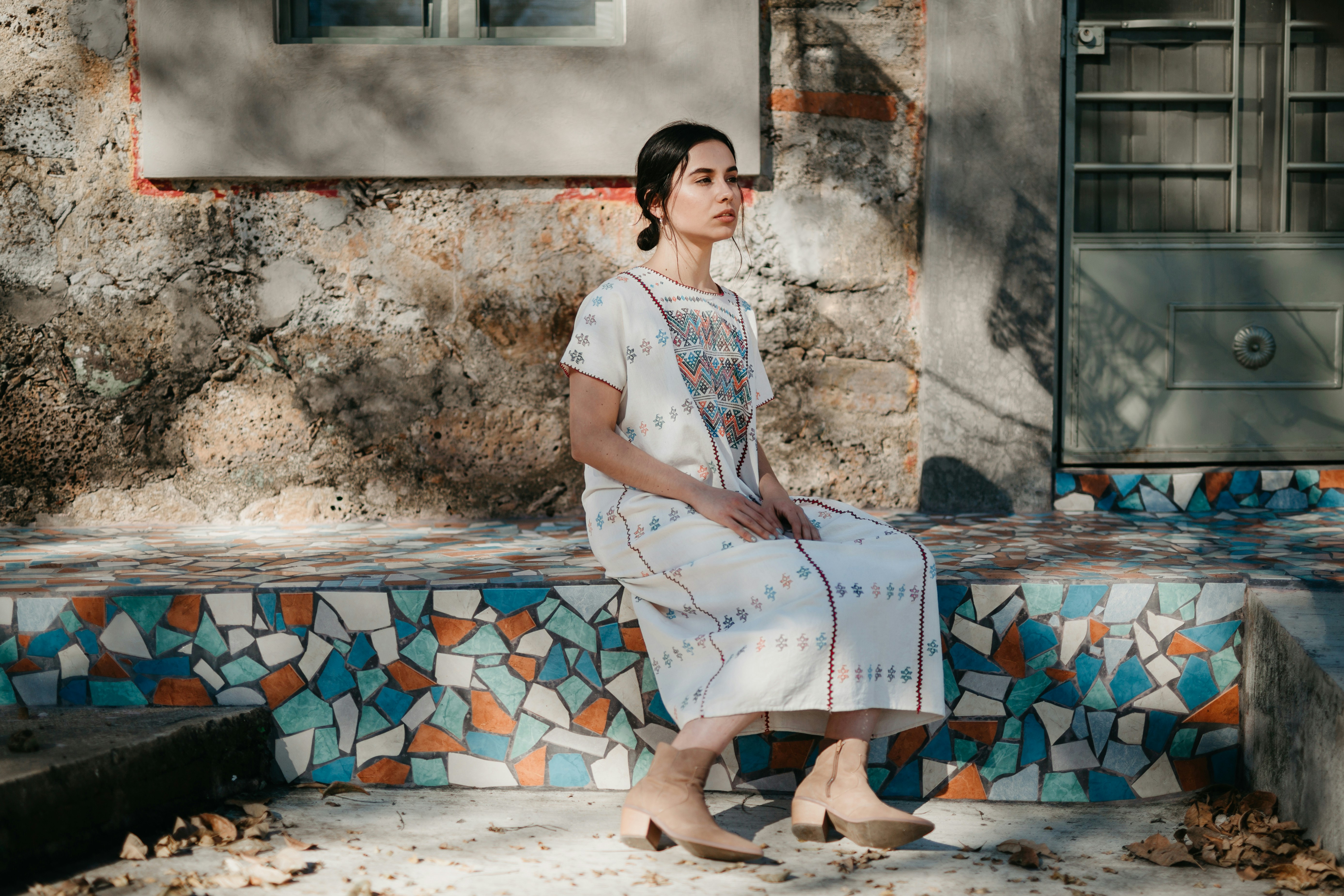 Woman in white dress on bench
