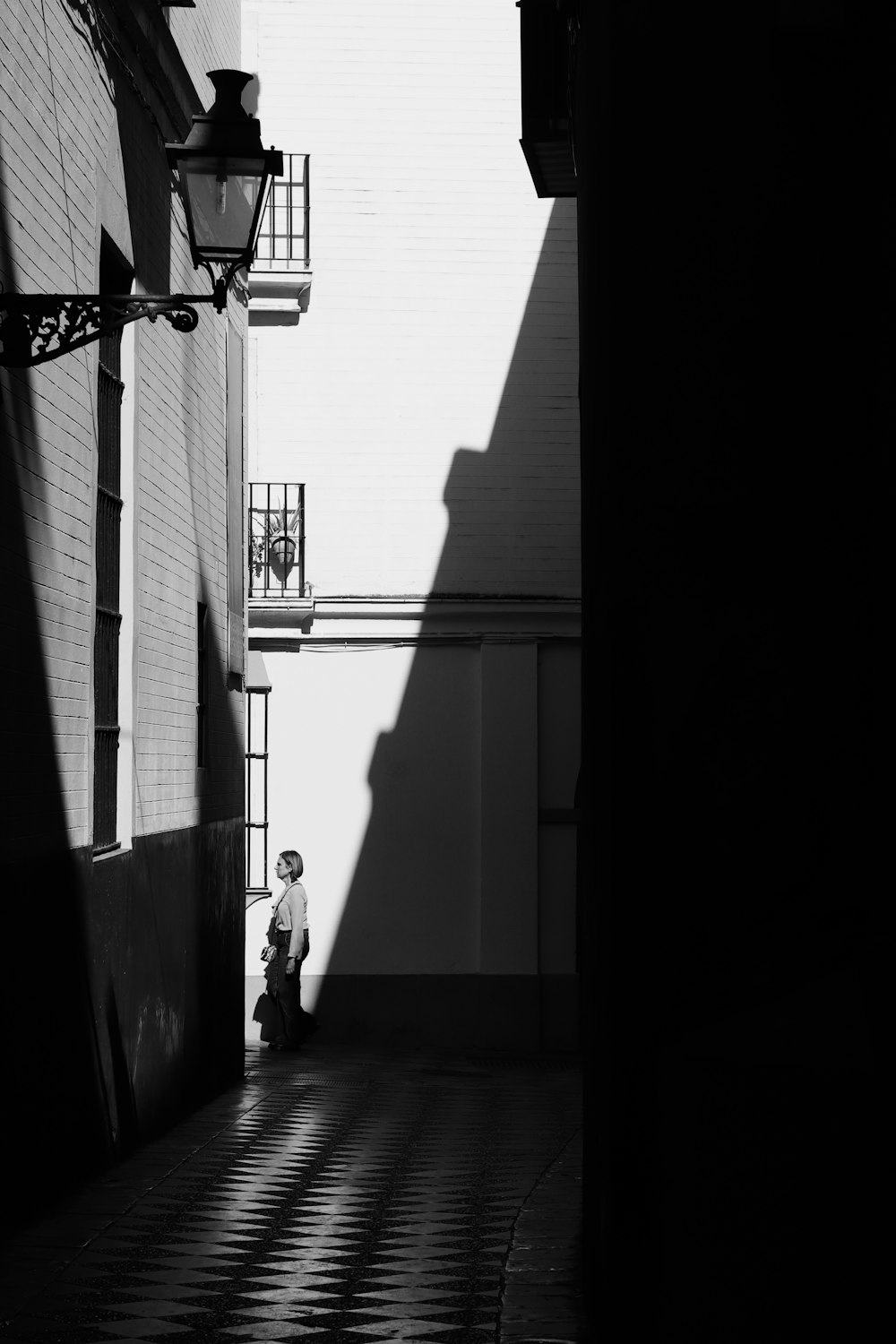 a person standing in an alley between two buildings