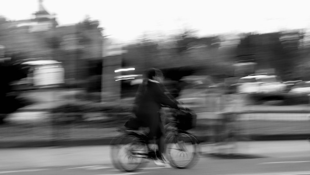 a blurry photo of a person riding a bike