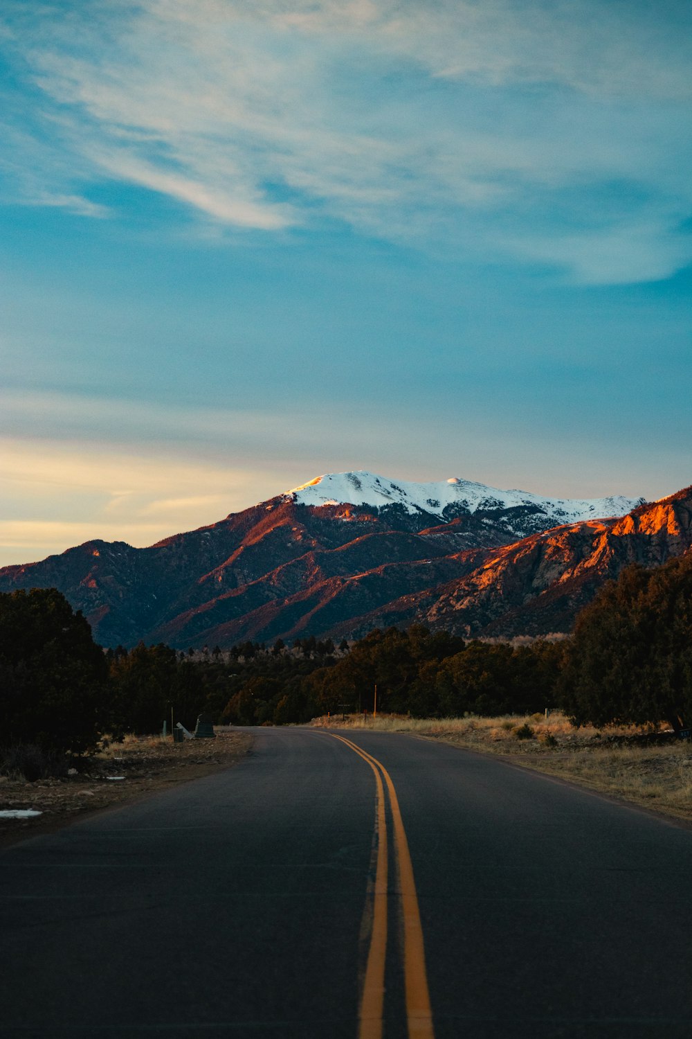 a road with a mountain in the background