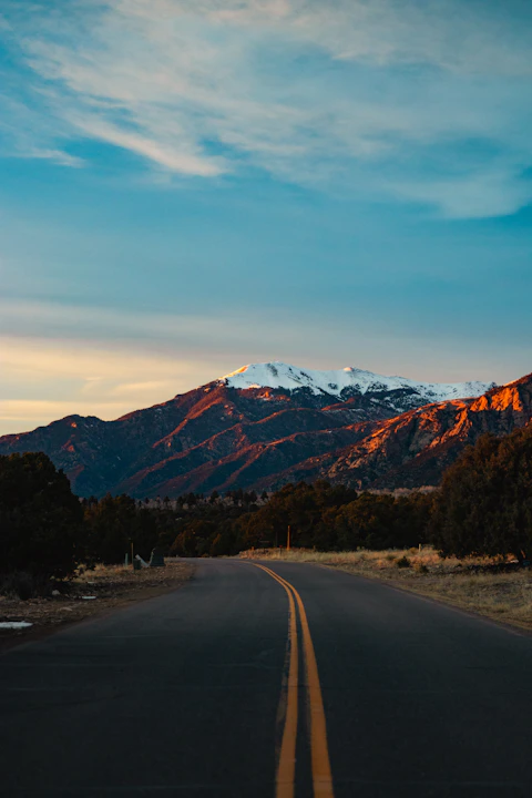a road with a mountain in the background