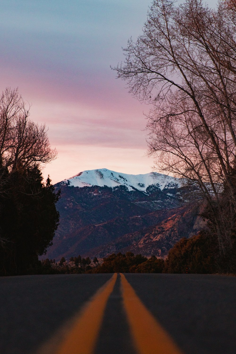 a long road with a mountain in the background