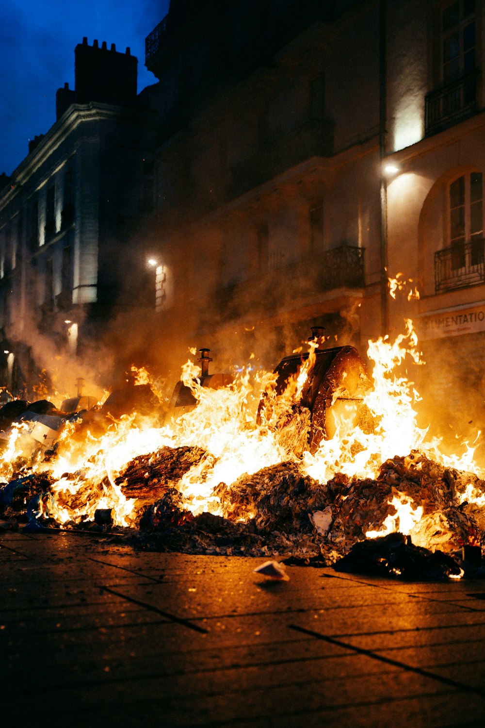 a large pile of fire in front of a building