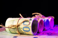 Vintage European banknotes arranged neatly on a dark background.