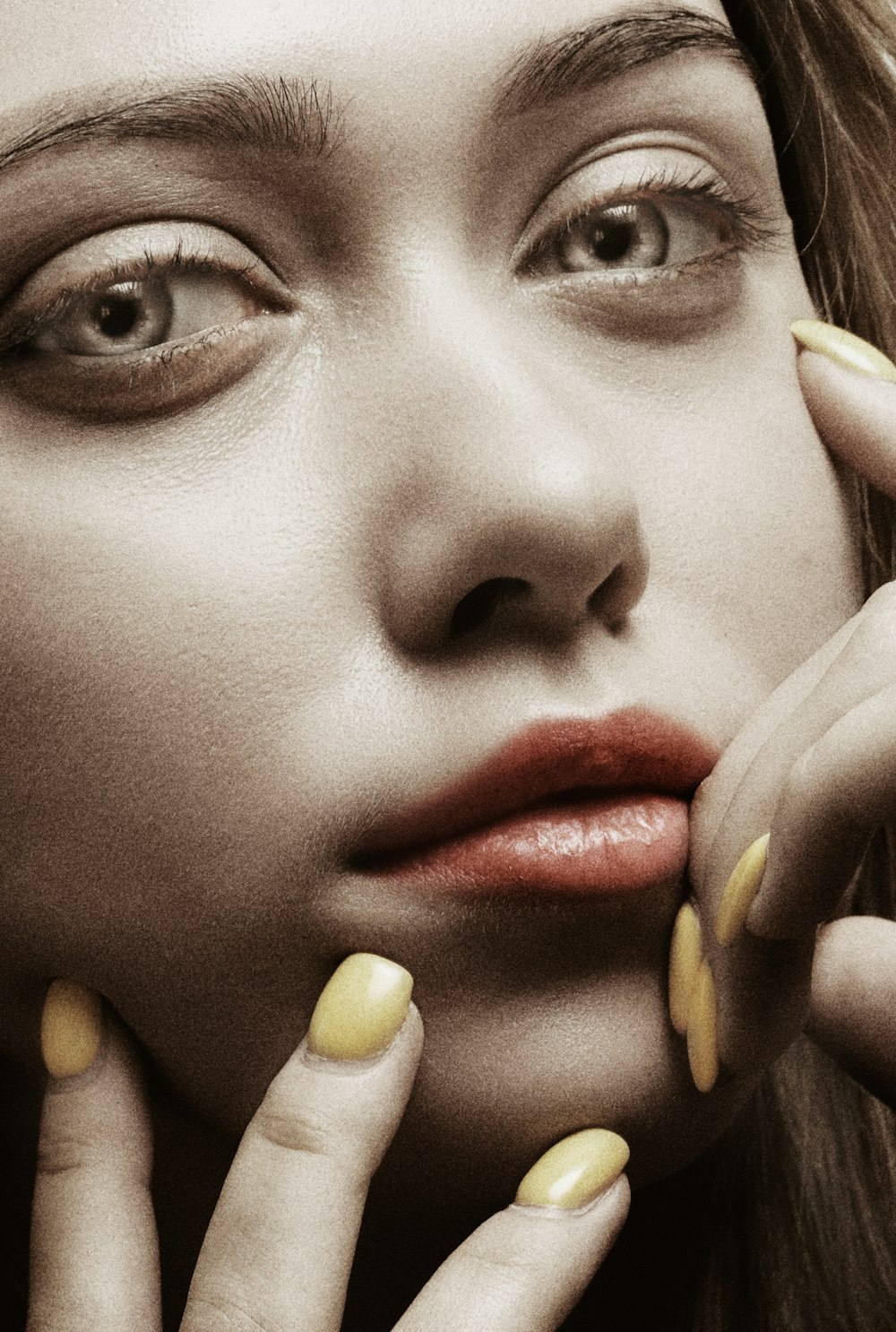 a woman with yellow nails posing for a picture