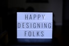 a sign that says happy designing folks on it