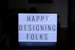a sign that says happy designing folks on it