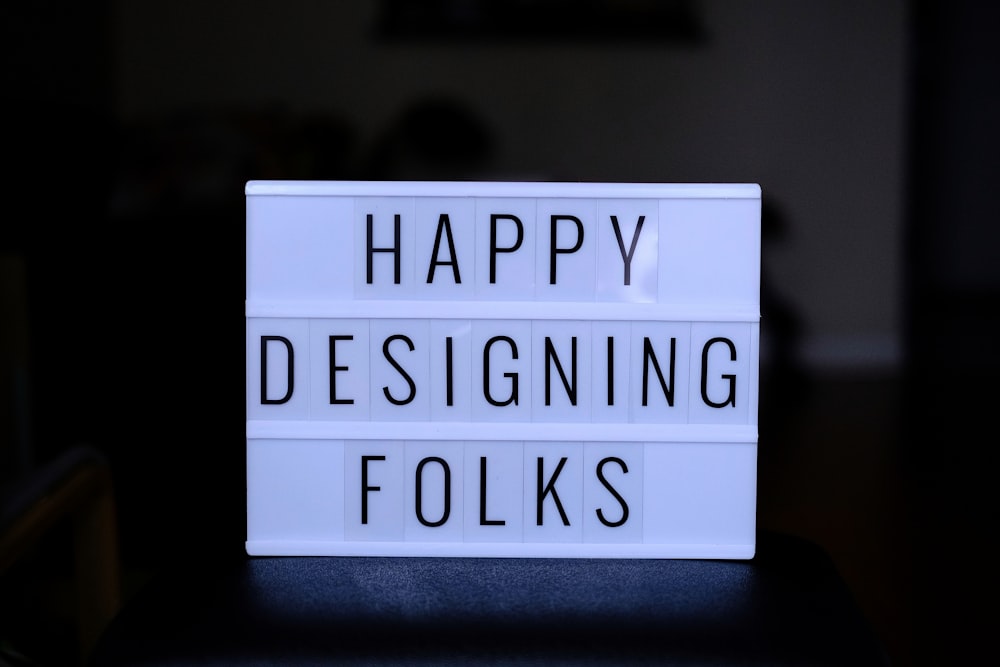 a sign that says happy designing folks on it