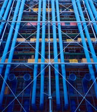 A commercial building with visible plumbing pipes and maintenance work