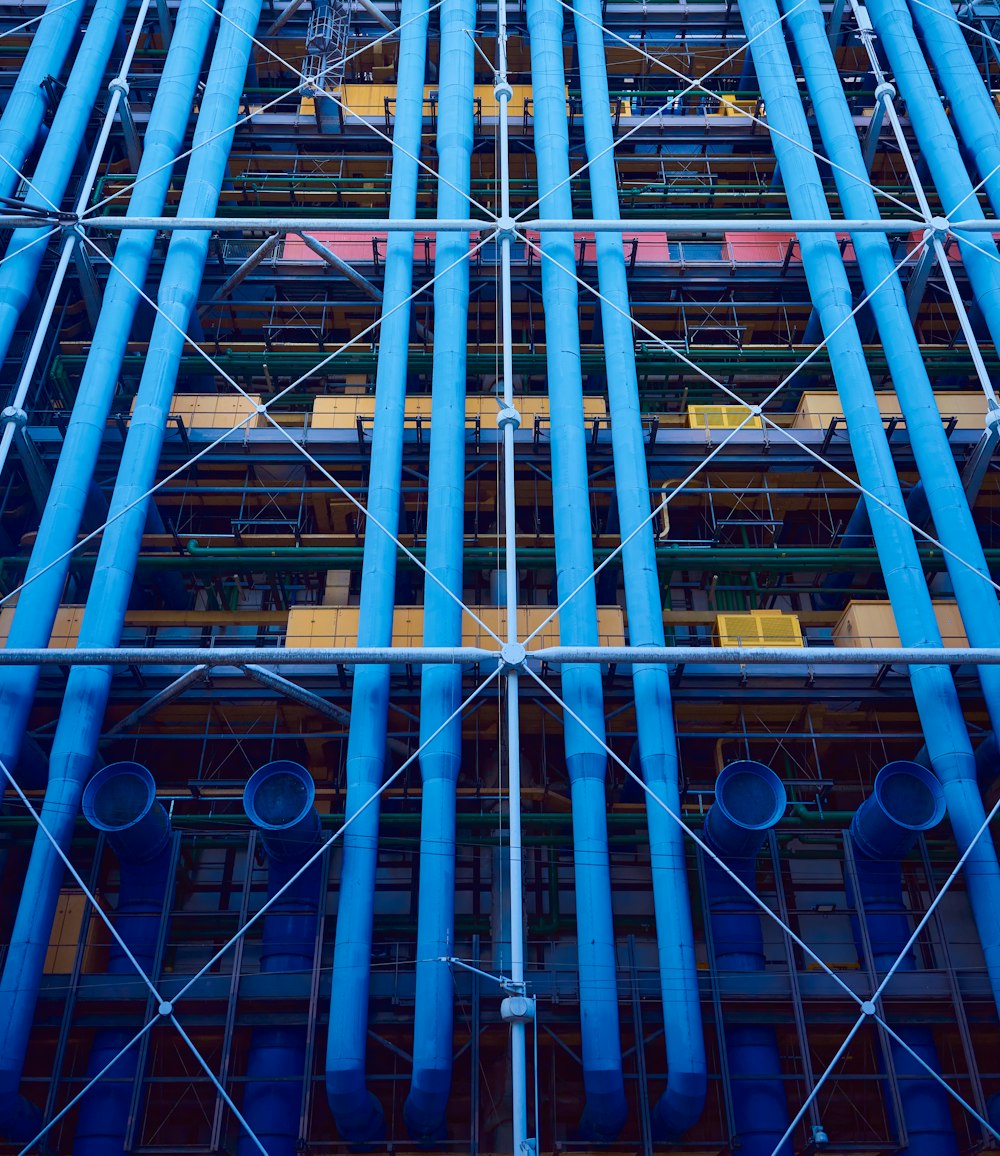 Ein sehr hohes Gebäude mit vielen blauen Rohren