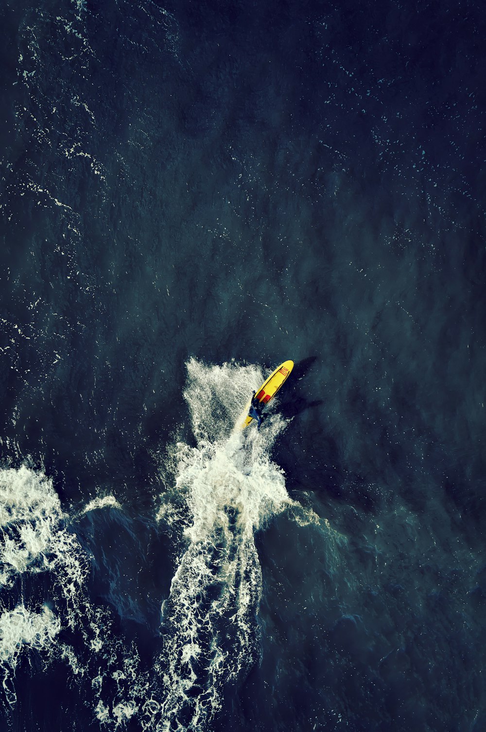 a yellow kayak in the middle of the ocean