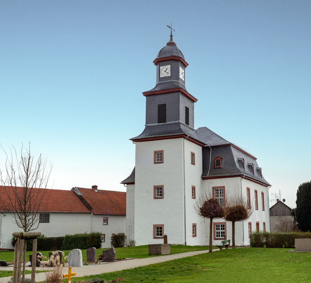 a large white building with a clock tower