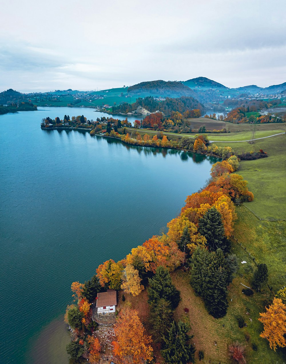 an aerial view of a lake surrounded by trees