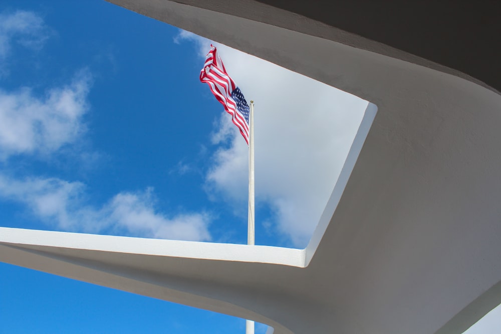 an american flag flying from the top of a building