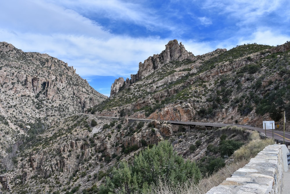 a mountain road with a bridge going over it