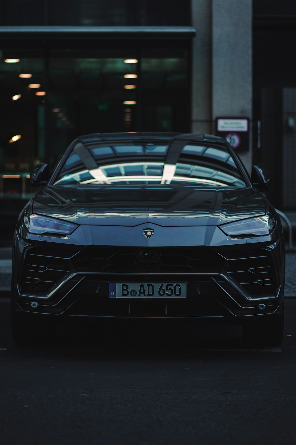 a black sports car parked in front of a building