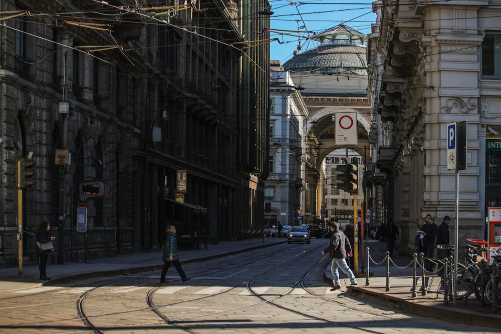 a couple of people that are walking down a street